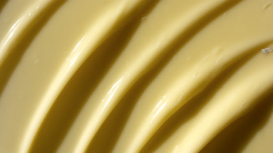 Texture of yellow anti-aging cream with vitamin E and CoQ 10
