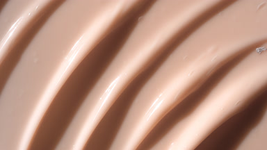 Top view macro texture of beige anti-aging cream with retinol