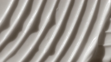 Macro shot of white lifting cream with moving light source