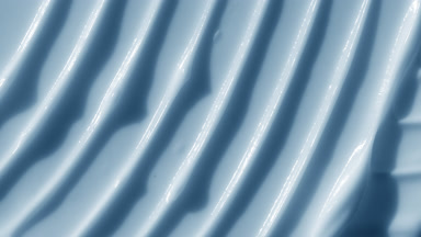 Macro shot of blue lifting cream with moving light source