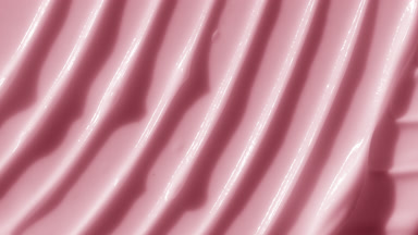 Macro shot of pink lifting cream with moving light source