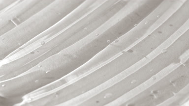 Side view macro turntable shot of white face care gel