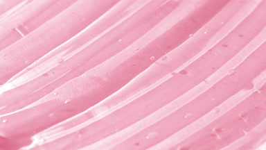 Side view macro turntable shot of pink watermelon face care gel