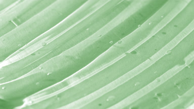 Side view macro turntable shot of green aloe vera face care gel