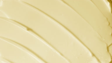 Top view macro turntable shot of yellow day cream with collagen