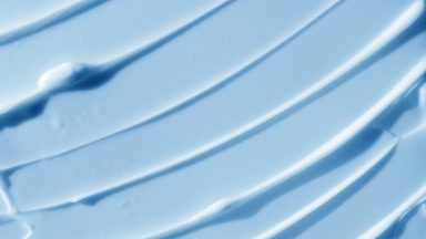 Top view macro turntable shot of blue body care cream