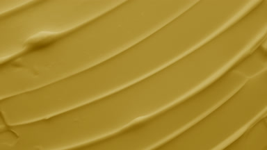 Macro of yellow moisturizing cream with sesame oil in the shadow