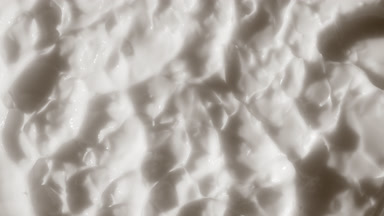 Top view macro shot of white nutrition cream surface
