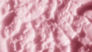 Top view macro shot of pink nourishing cream surface