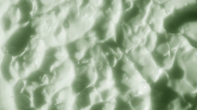 Macro shot of green nourishing cream with green tea oil surface
