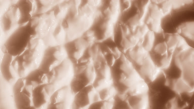 Beige nourishing cream surface with carrot oil and shea butter