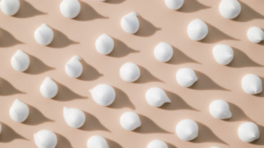 Whitening cream drops on beige background with moving lighting