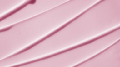 Top view macro turntable shot of pink day cream wave texture