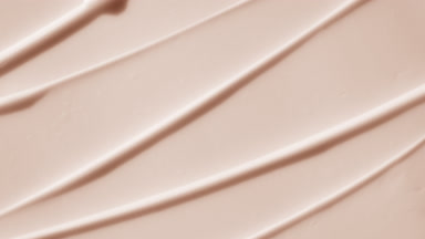 Top view macro turntable shot of beige day cream wave texture