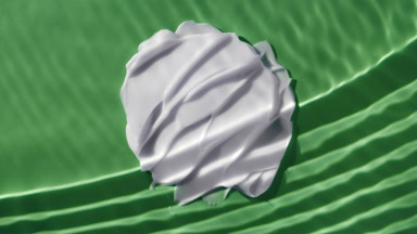 White cream smears on green background under rippling water