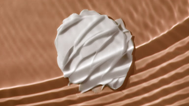 White cream smears on beige background under rippling water