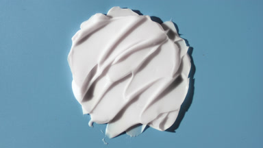 White day cream smears on blue background with moving light