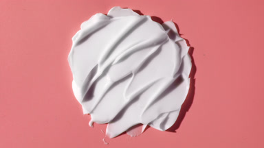 White day cream smears on pink background with moving light