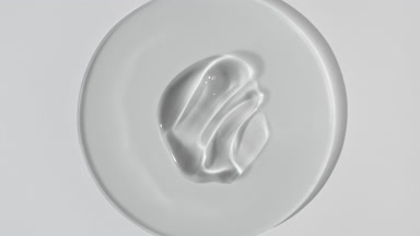 Body gel smears on glass appear from shadow on white background