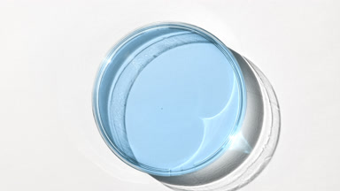 Blue gel on watch glass is covered by shadow on white background