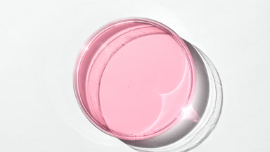 Pink gel on watch glass is covered by shadow on white background