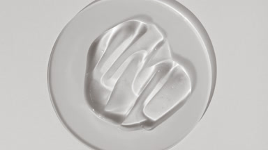 Gel smears on watch glass appear from shadow on white background
