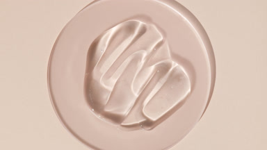 Gel smears on watch glass appear from shadow on beige background