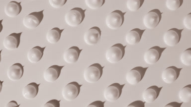 Whitening cream drops appear from shadow on white background