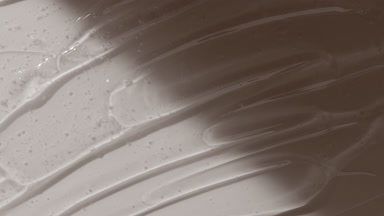 Colorless gel texture on white background appear from the shadow