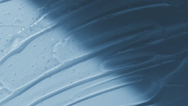 Colorless gel texture on pale blue background appear from shadow