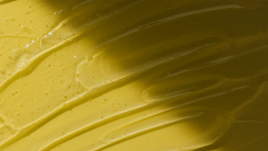Colorless gel texture on yellow background appear from shadow