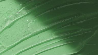 Colorless gel texture on green background appear from the shadow