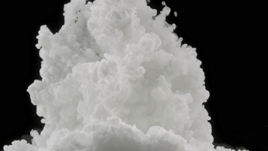 White ink injected in water fills whole shot on black background