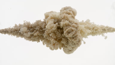 Beige and brown ink injected in water mixing on white background