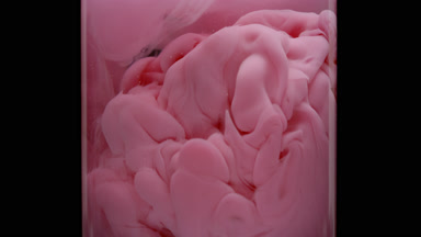 Macro of pink ink injected in test tube with water fills it