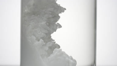 White ink fills test tube with water being injected in it
