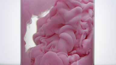 Pink ink fills test tube with water being injected in it