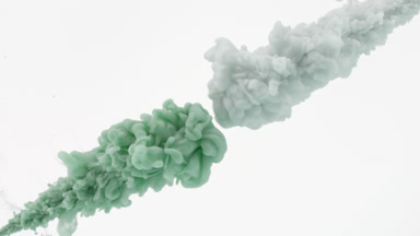 Green and grey inks injected in water from two corners mixing
