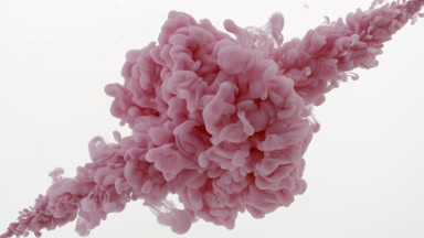 Pink ink injected in water from two corners on white background