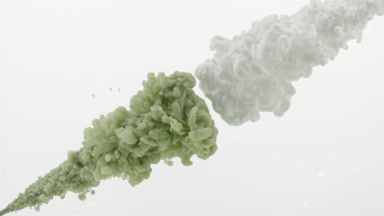 Green and white inks injected in water from two corners mixing