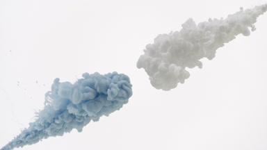 Blue and white inks injected in water mixing on white background