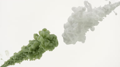 Green and white inks being injected in water on white background