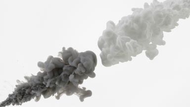 Black and white inks being injected in water on white background