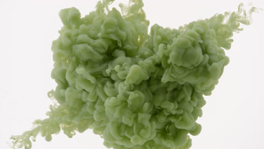 Green ink injected in water from two corners on white background