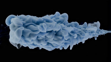 Macro of blue ink is being injected in water on black background