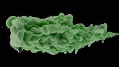 Dark green ink is being injected in water on black background