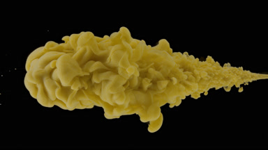 Macro of yellow ink being injected in water on black background