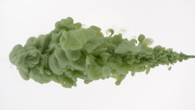 Macro of green ink being injected in water on white background