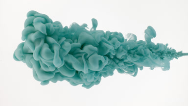 Macro of cyan ink is being injected in water on white background