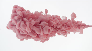 Pink ink being injected in water filling almost the whole shot